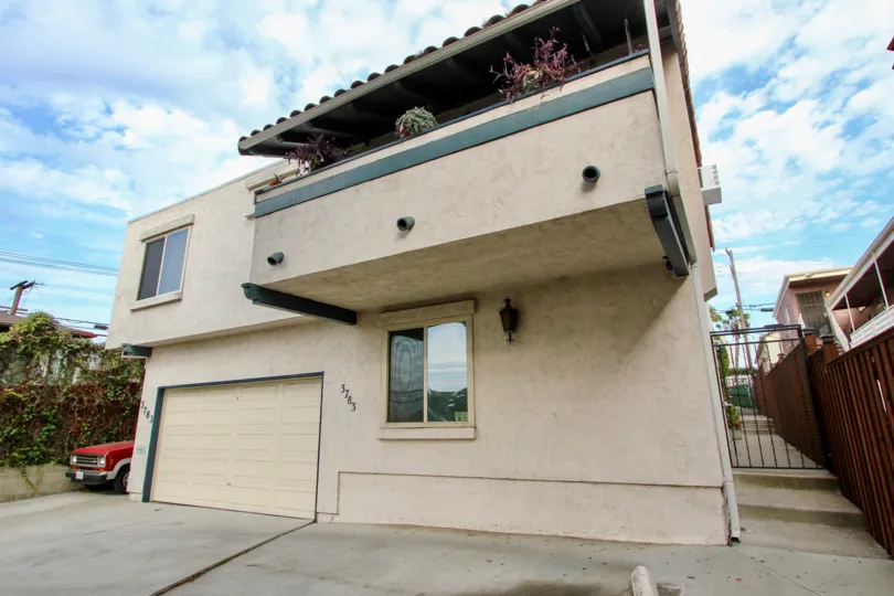 Balcony garden overlooking single garage home with a privacy fence at address 3783