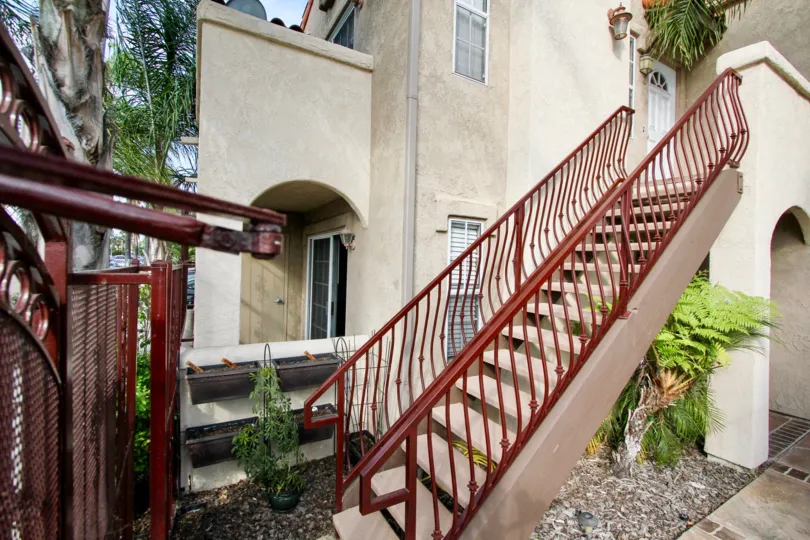 Side view of red stairs leading up to a home in Swift Park community in North Park, California