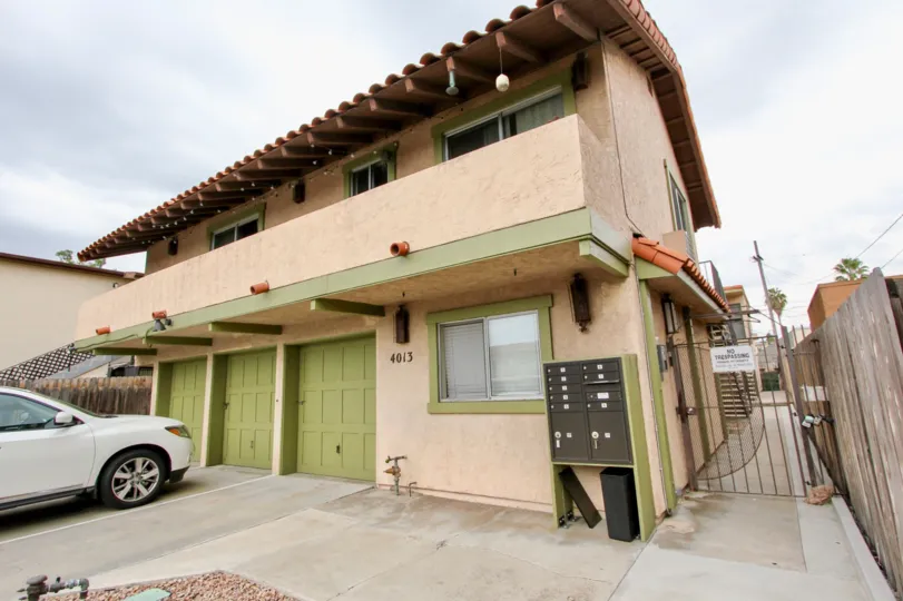 Front of house with three garage doors in the Texas Street Condos