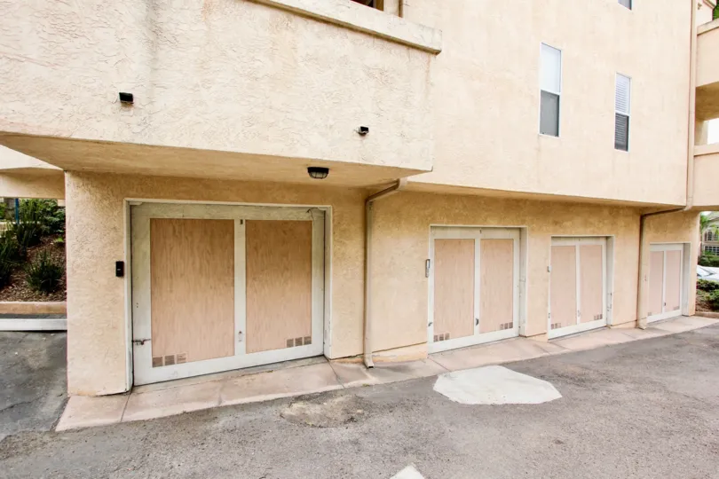 A sunny day in the area of Uptown Villas, barn doors, garage, condos, parking lot