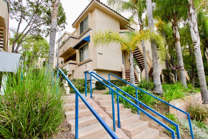 Front of residence with main ladder and a lot trees in the yard in the Uptown Villas
