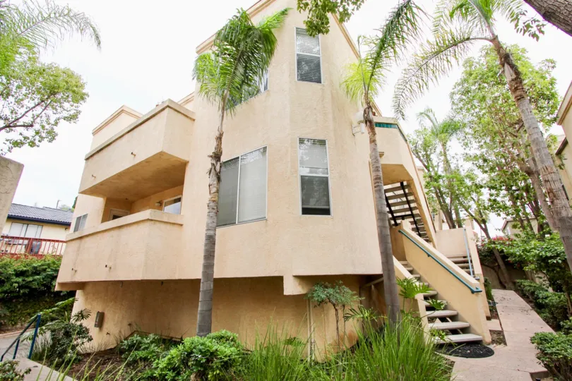 Uptown Villas community North Park California palm trees decorative grass landscaping stairs covered porch balcony windows garden