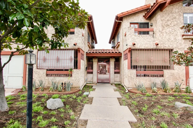 Two brown residential buildings with bars on their windows inside Utah Park II in North Park CA