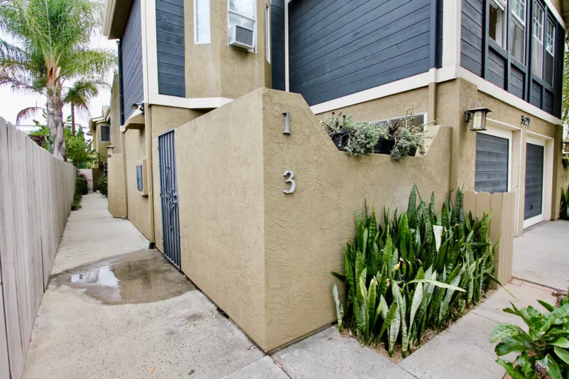 Side ally and front garage view of Victorian House VI in North Park, CA