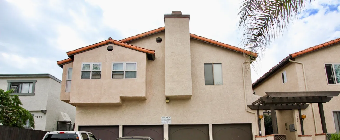 Outside view of a cream colored unit with a chimney located in Villa Park of North Park, California