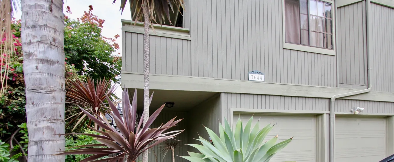 Black iron gateway next to a residential building at Villa Terrace in North Park California
