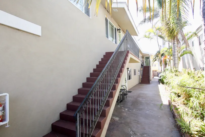 Outside stairs leading to the second floor on an alley between two buildings at 4841 Del Monte Ave.