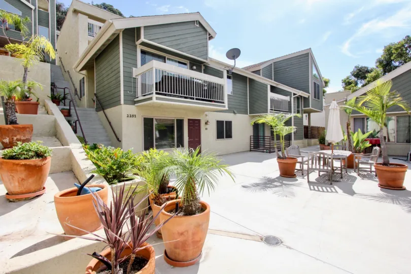 Large expansive courtyard with potted plants and outdoor seating with terraced gardens at Bay Pointe