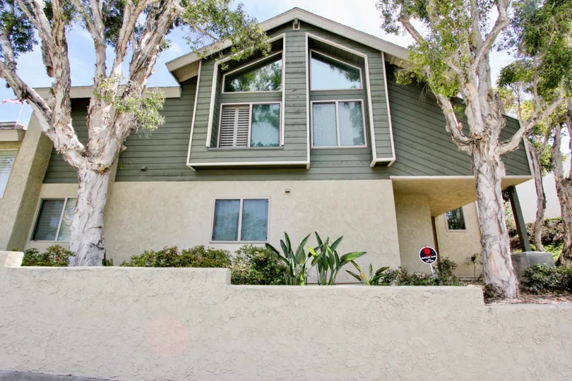 A two-storey house painted in green in Bay Pointe village.