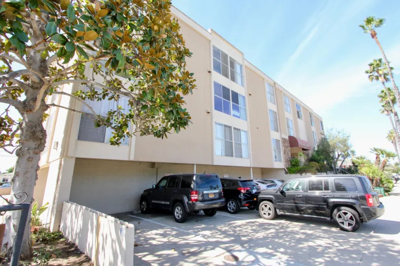 A SUNNY DAY IN THE CAPE MAY TOWERS WITH THE APARTMENT, CAR PARKING, TREES