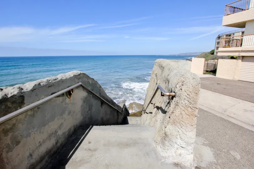 Paved walkway and stairs leading to the beach adjacent to Casa De La Playa