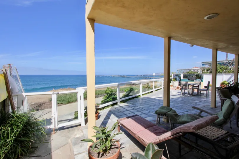 Mostly clear skies at Cliff House patio and lounging area over looking the ocean and pier.