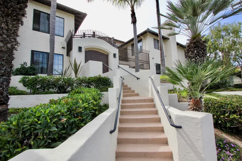 Large two-story house with gate and winiding stairs, located in Famosa Terrace, Ocean Beach, California.