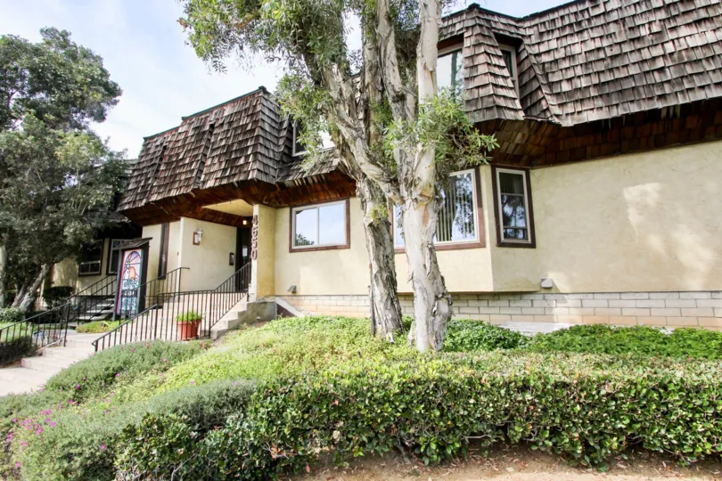 Two story home with stairs, and trees in front, located in Loma Pacific, Ocean Beach, California.