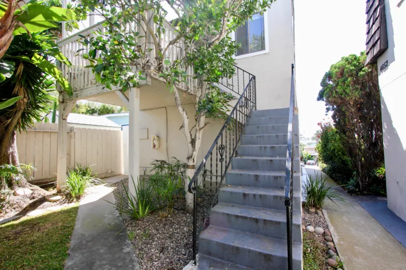 View of stairs leading towards a house with a shadow of trees at Narragansett Villas