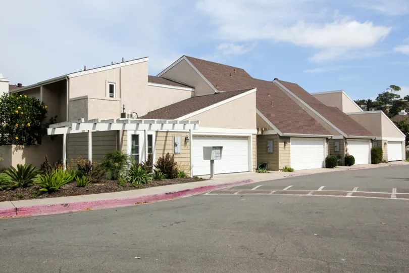 Speedbreaker is placed in front of the house has bushes and plants