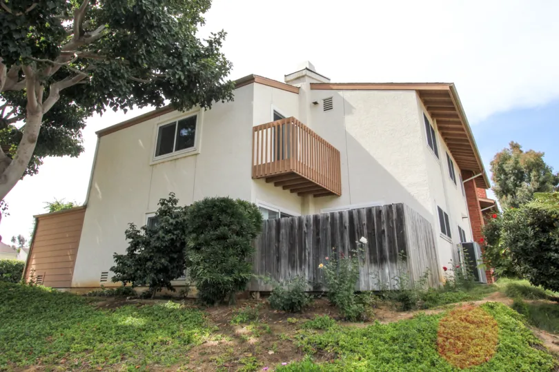 Two-story home on a hill with small second floor balcony, in Park Point Loma, Ocean Beach, California.