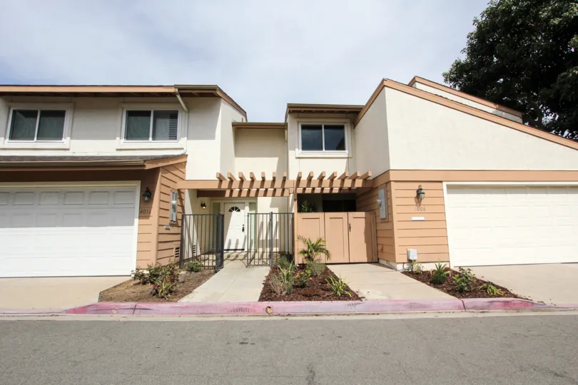 Road side view of a lovely two story duplex in Ocean Beach, California that have roomy garages and plenty of living space.