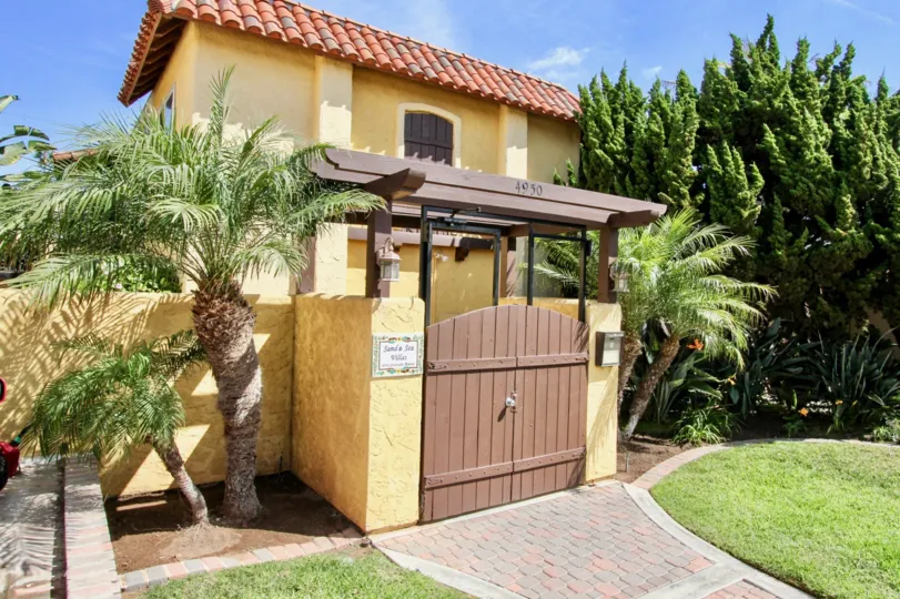 Awesome decorated entrance in front of the building with plants and trees in Sand & Sea Villas