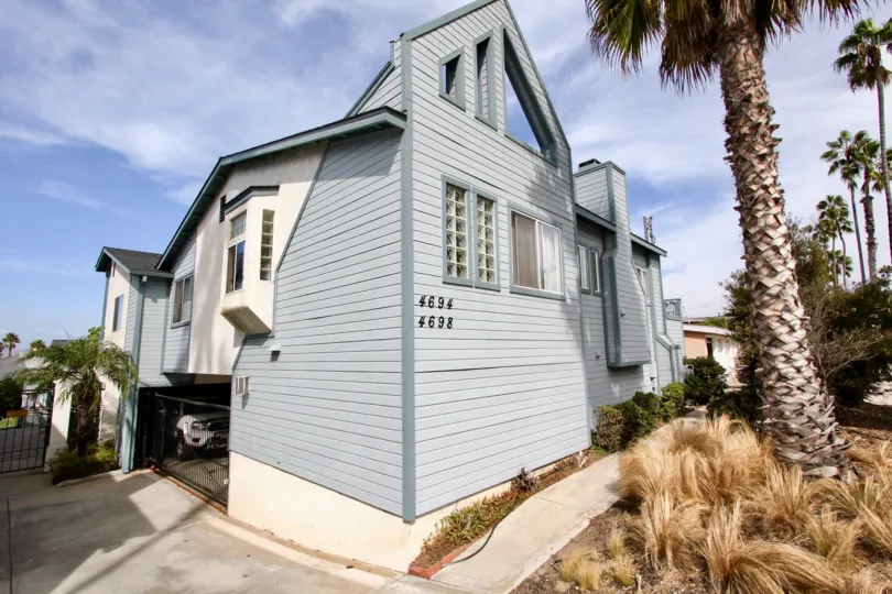 View of a beautiful house with well built structure and a parking space surrounded by tree at Spinnaker