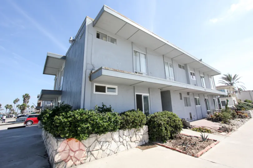 An extended portion of roof provides shade for the walkway at Spray condos