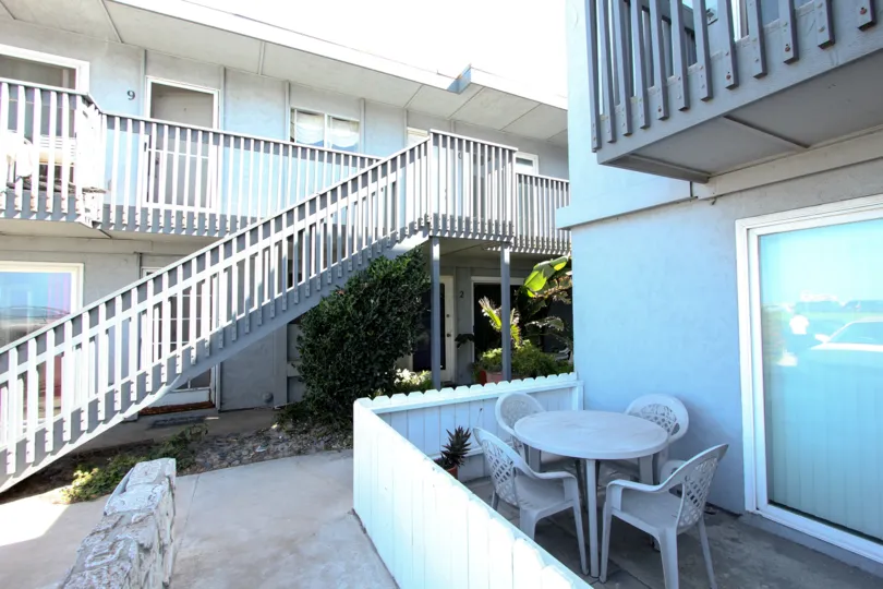 A white patio table inside Spray at Ocean Beach California