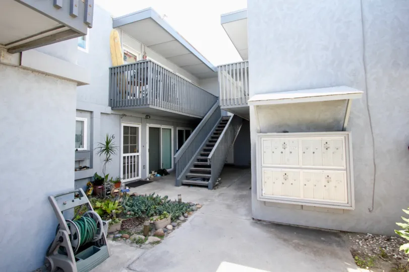 Private courtyard with mailboxes and a small garden with balconies in Ocean Beach