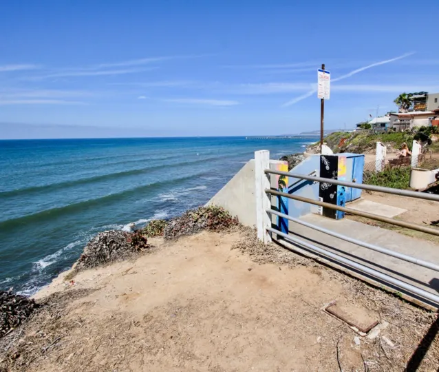 Dirt area overlooking the ocean, beside homes and gates, located at Sunset Towers, Ocean Beach, California.