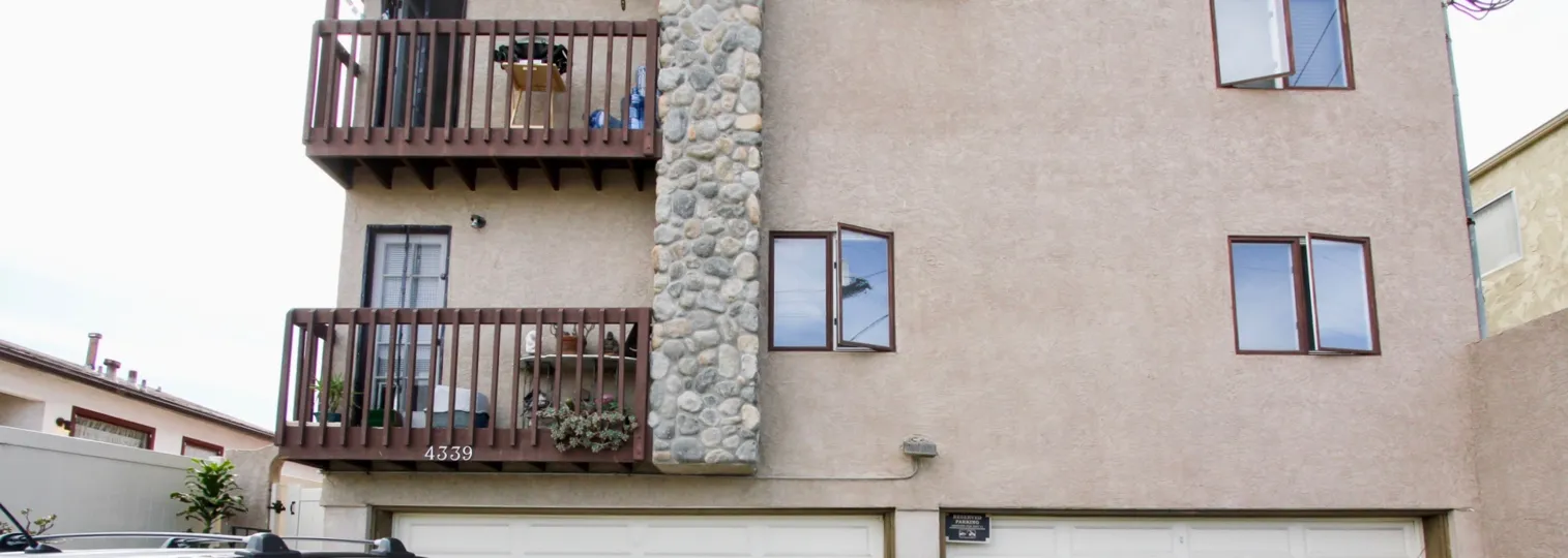 Two balconies and the garages of a building in Tangerine Tree in Ocean Beach, CA.