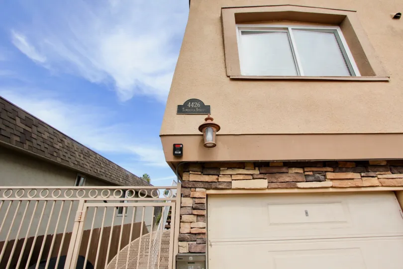 A house in Temecula Heights has number 4426 with light lamp attached to the wall