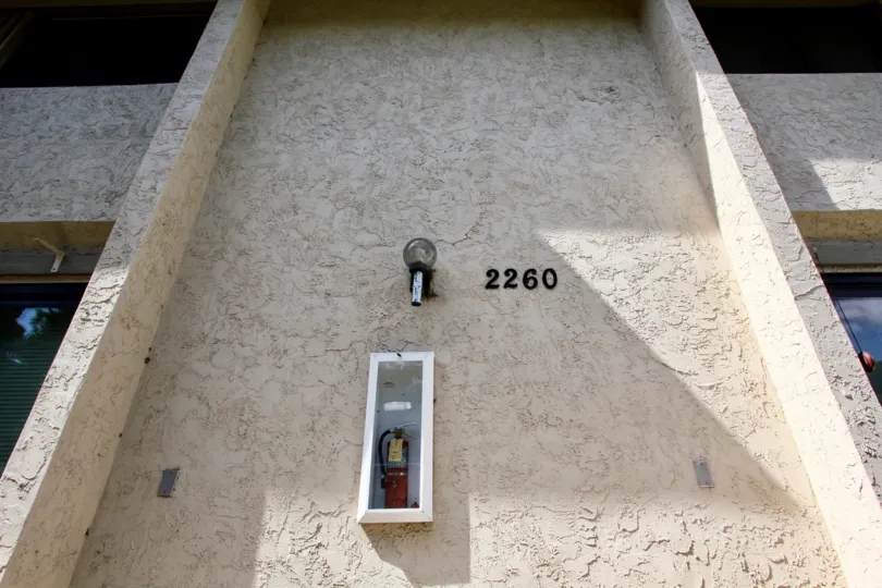 A fire extinguisher with unit number on the wall of Worden Street Condos community.