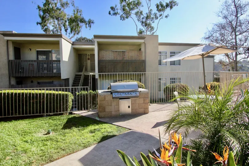 Two balconies with a nice fencing and green grass and trees.