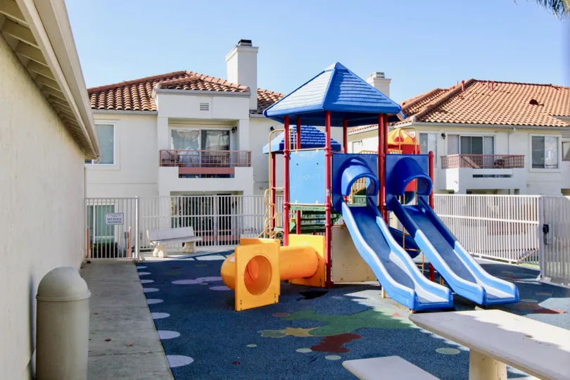 Avalon at Eagles Crossing, Oceanside, California. kid's slide, blue sky.