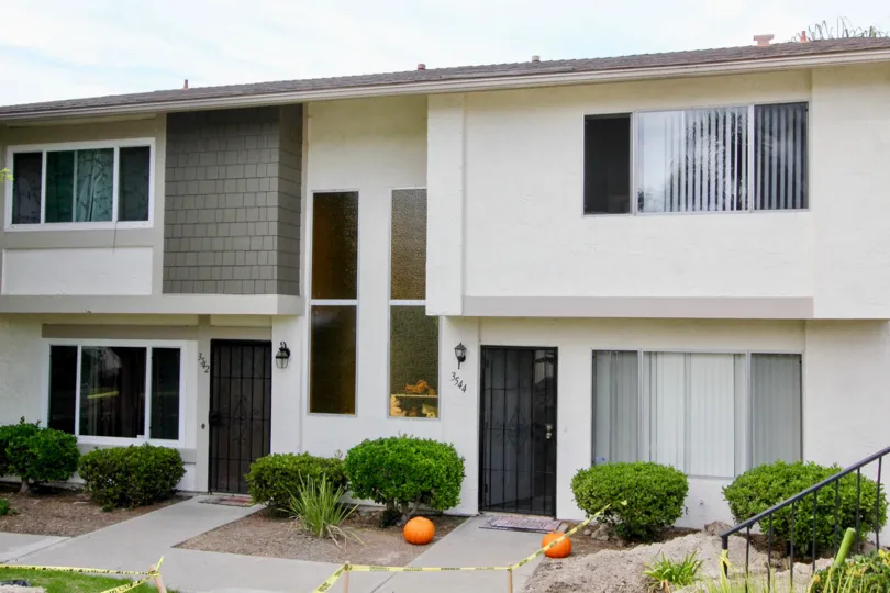 Bay Shores, Oceanside, California, trimmed bushes, black door.