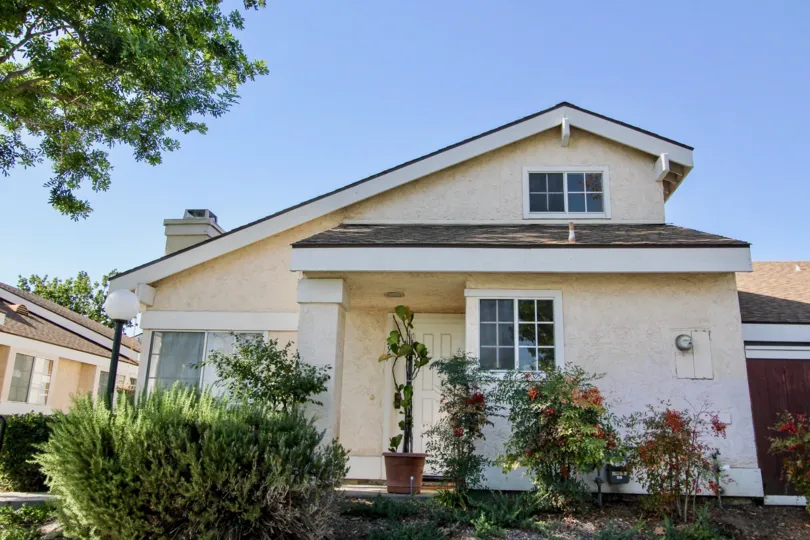 Well manicured lawn and landscape at this slant roof home in Carefree Village at Oceanside, CA