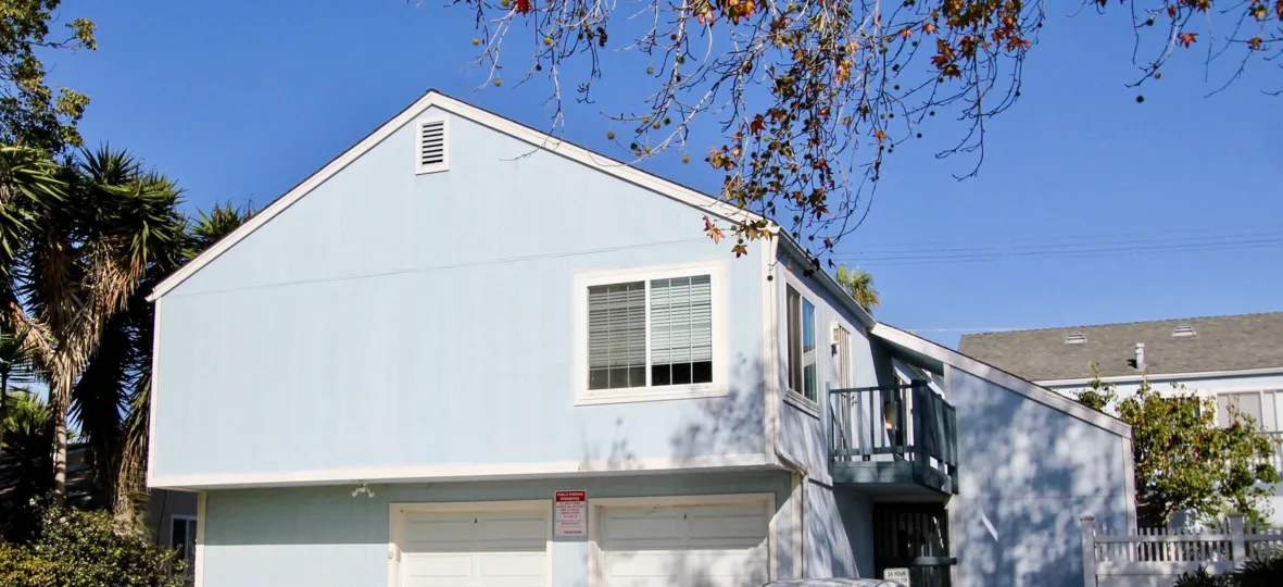 In Driftwood Estates a community in Oceanside, Ca a street boats tan homes.