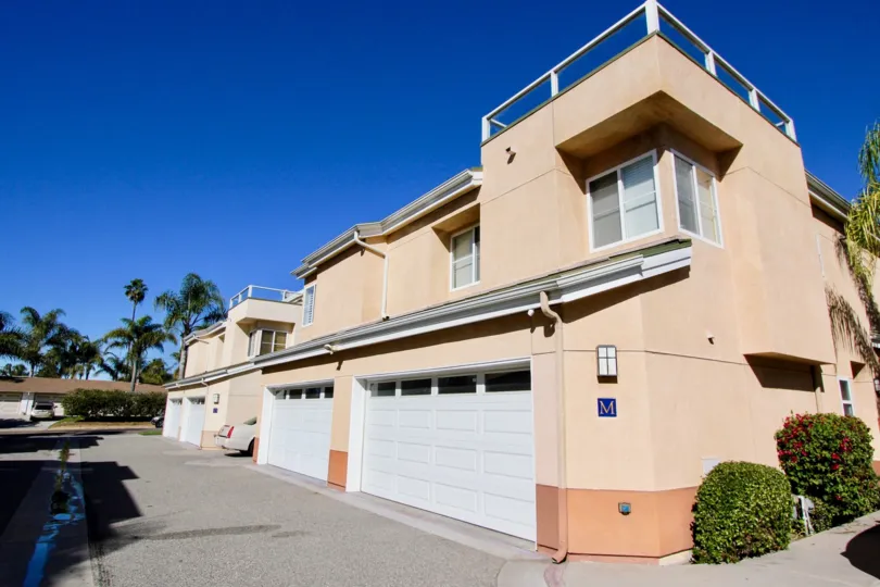 Four garages with white doors built into Eaton Court in Oceanside CA