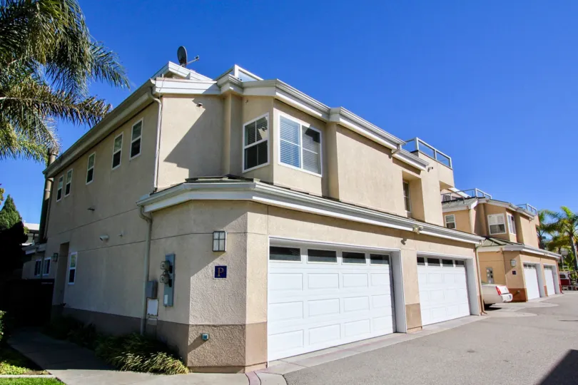 In Eaton Court a community in Oceanside, Ca a street boats tan homes.