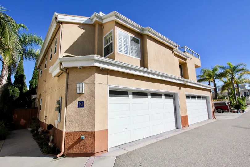 A brown residential building with two garages in Eaton Court in Oceanside California