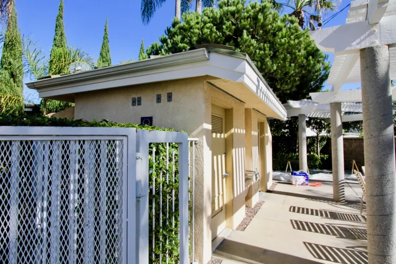 Small white building near swimming area inside the Eaton Court community in Oceanside CA