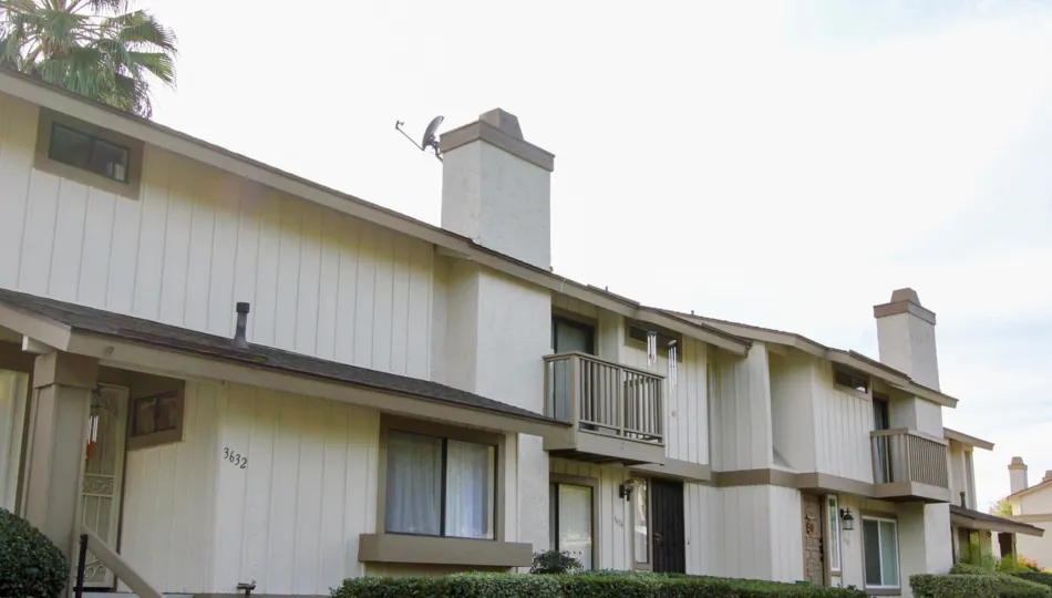 A two story property with porches and chimneys at El Camino Club Estates