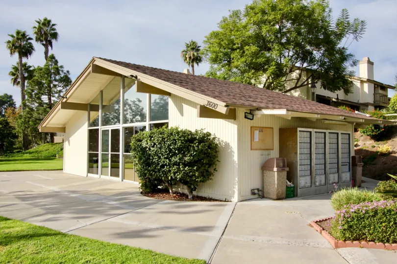 A sunny day in the area of El Camino Club Estates, outside, lockers, bushes, trees