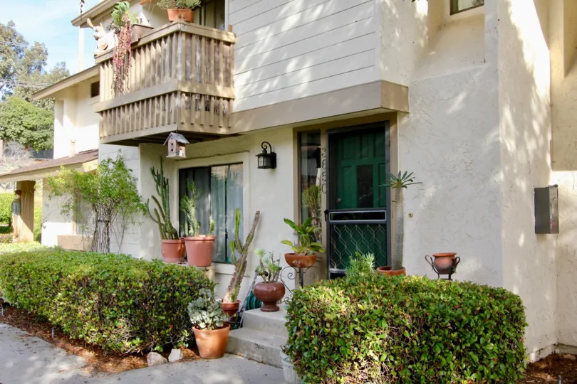 Two story homes with dark green doors inside El Camino Club Estates at Oceanside California