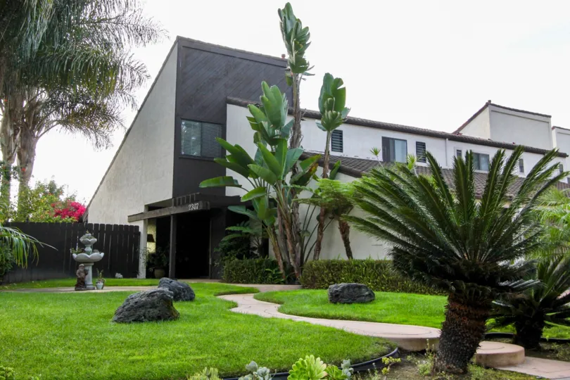 Backyard park with green grass lawn of El Camino Villa.