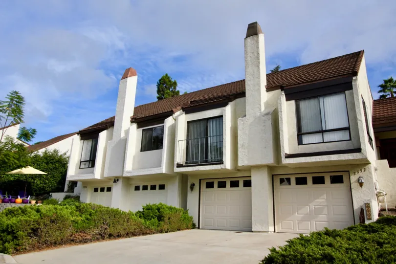 Private garage entrances with large bright windows at El Camino Villa.