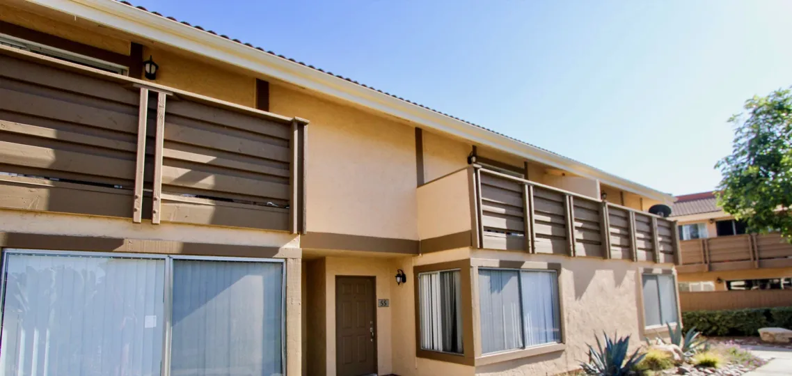 An exterior view of the Forest Glen apartments showing second story balconies and front entrances.