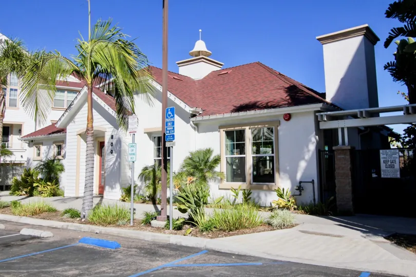 A sunny day in the area of Harbor Cliff, outside, parking lot, palm trees. gated entrance