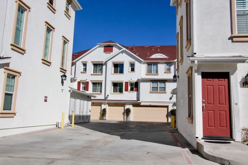 An parking area with red doors and roofs at Harbor Cliff
