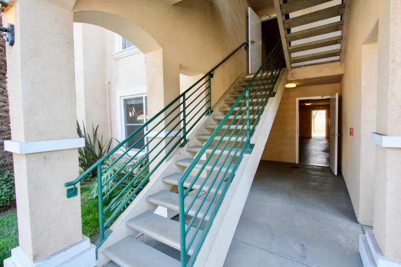 A small yard by stairs leading to a unit in La Costa Villas in Oceanside, CA
