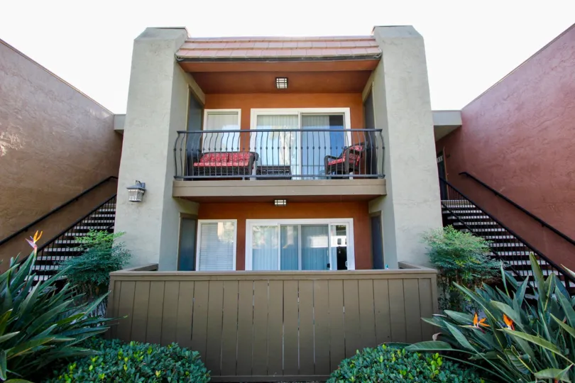 A sunny day in the area of La Estancia, condo, outside, balcony, couch, chair, bushes, stairs